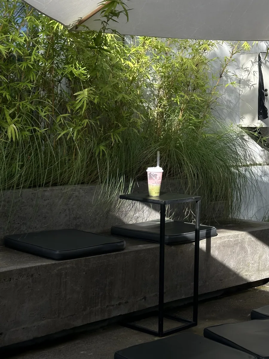 Shaded outdoor terrace with bamboo and concrete benches